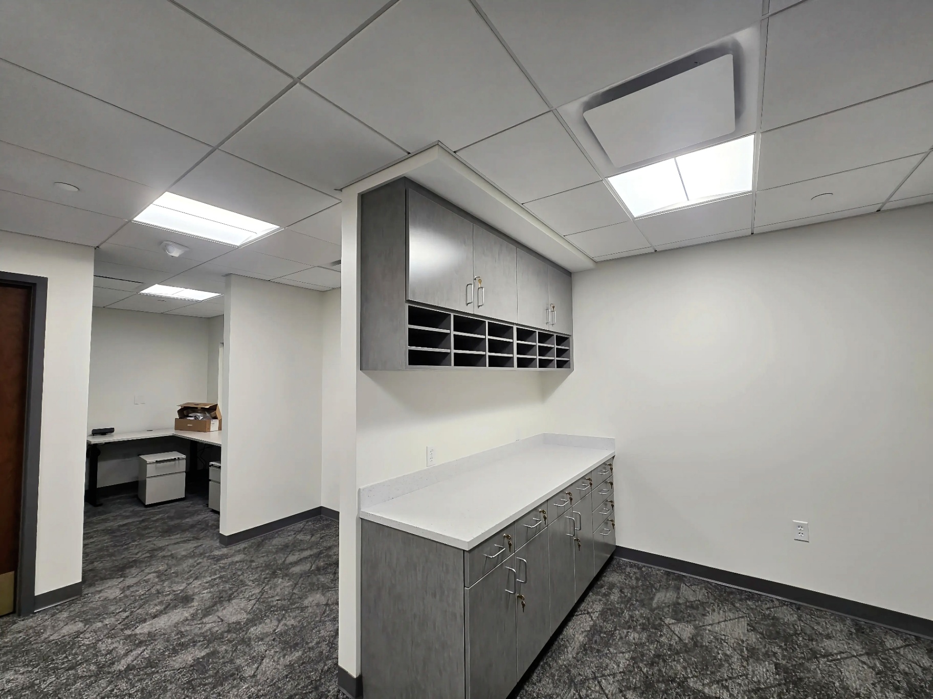 Office Mailroom Power & Lighting — Troffer lighting, dedicated outlets, and tidy device finish-out for an office mailroom build-out.