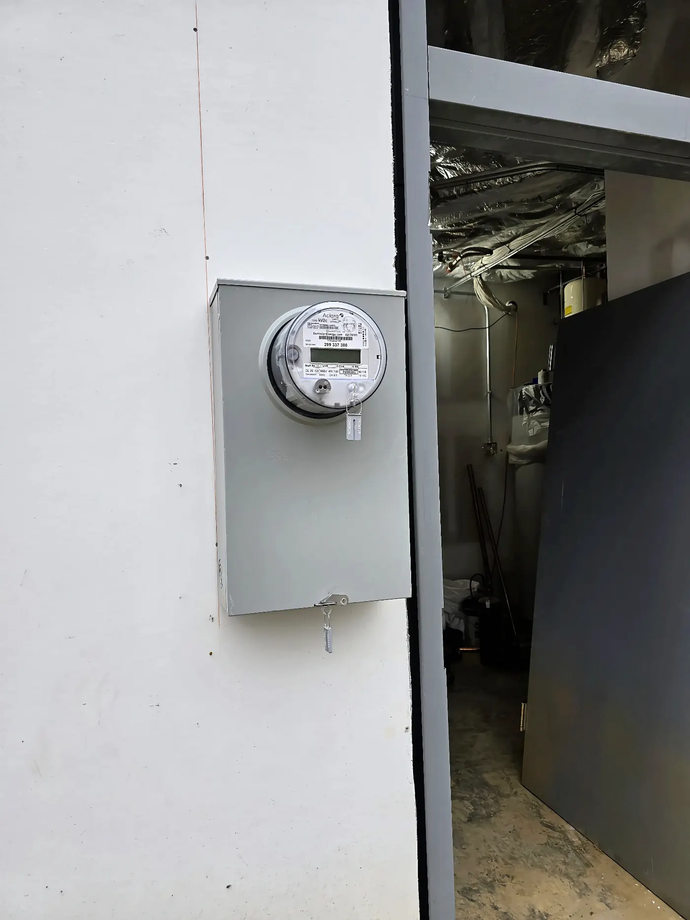 Commercial Meter Base Installation — Dominion Energy meter base set and terminated on a commercial wall — ready for utility energization.