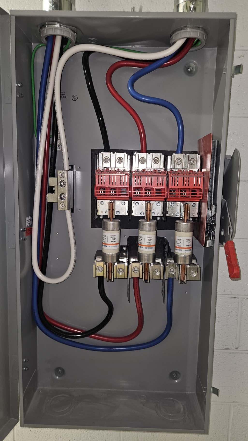Heavy-Duty Fused Service Disconnect — Three-phase fused disconnect with color-coded service entrance conductors landed clean on copper.