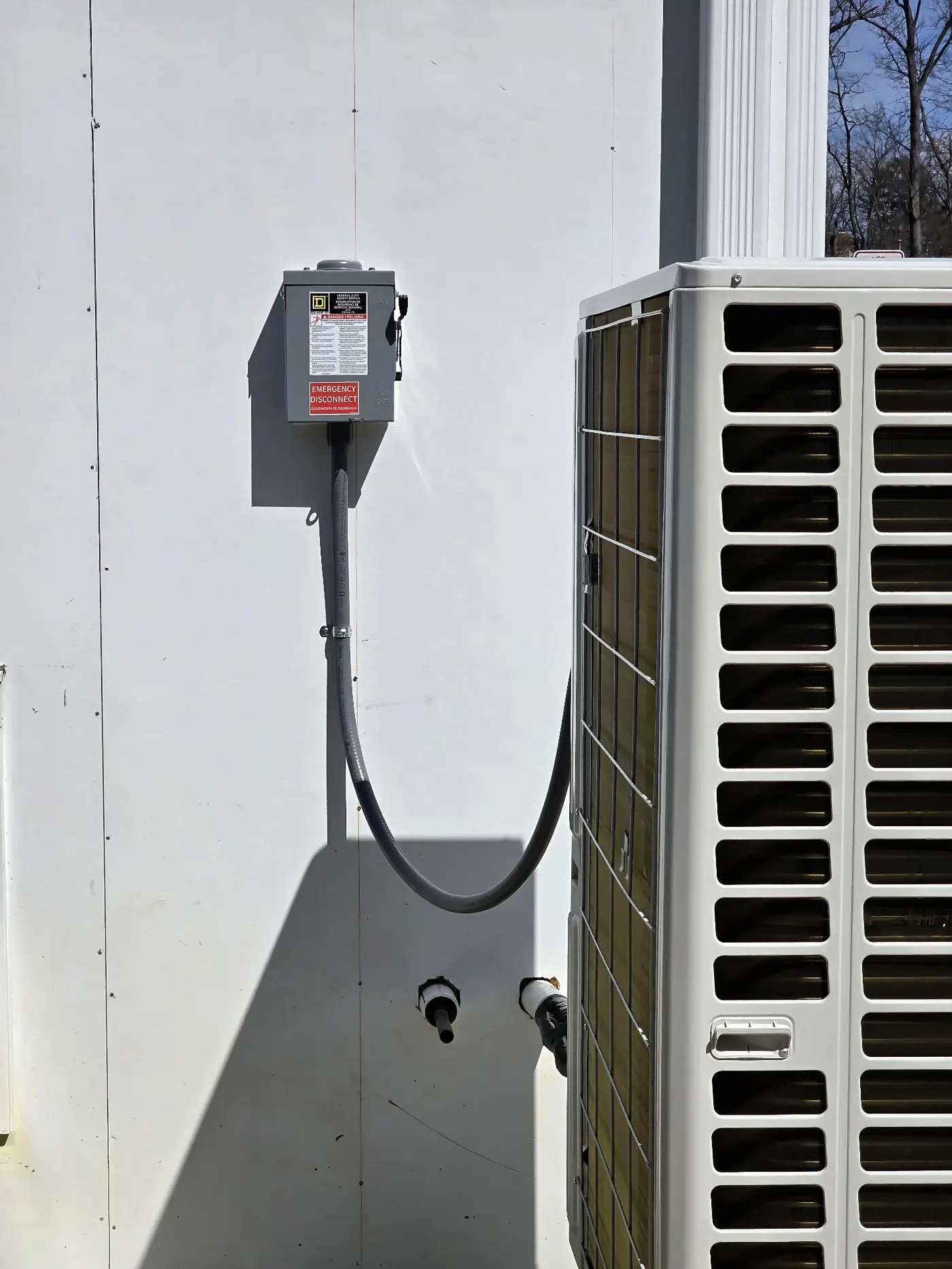 HVAC Disconnect & Condenser Hookup — Exterior fused HVAC disconnect wired to a new condenser unit with sealed weather-tight whip.